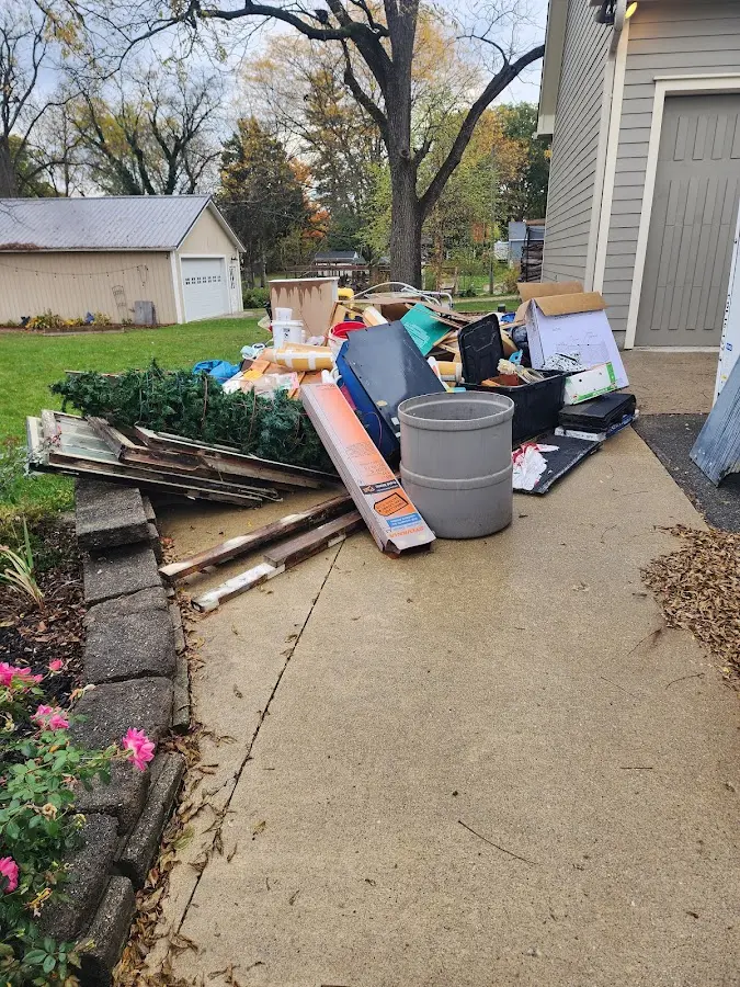 Dumpster being loaded with debris for Roofing Dumpster Rental in Asbury